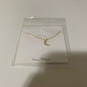 Gold tone kris nations moon necklace
